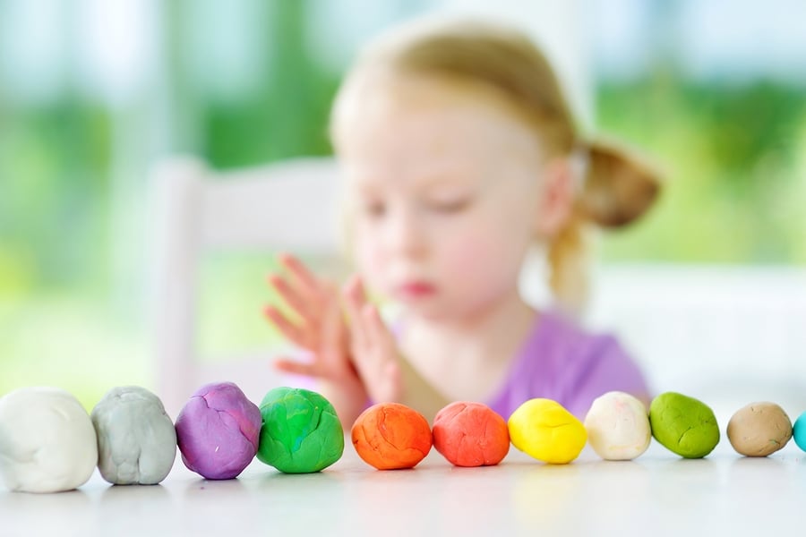 Cute Little Girl Having Fun With Modeling Clay At A Daycare. Cre ...