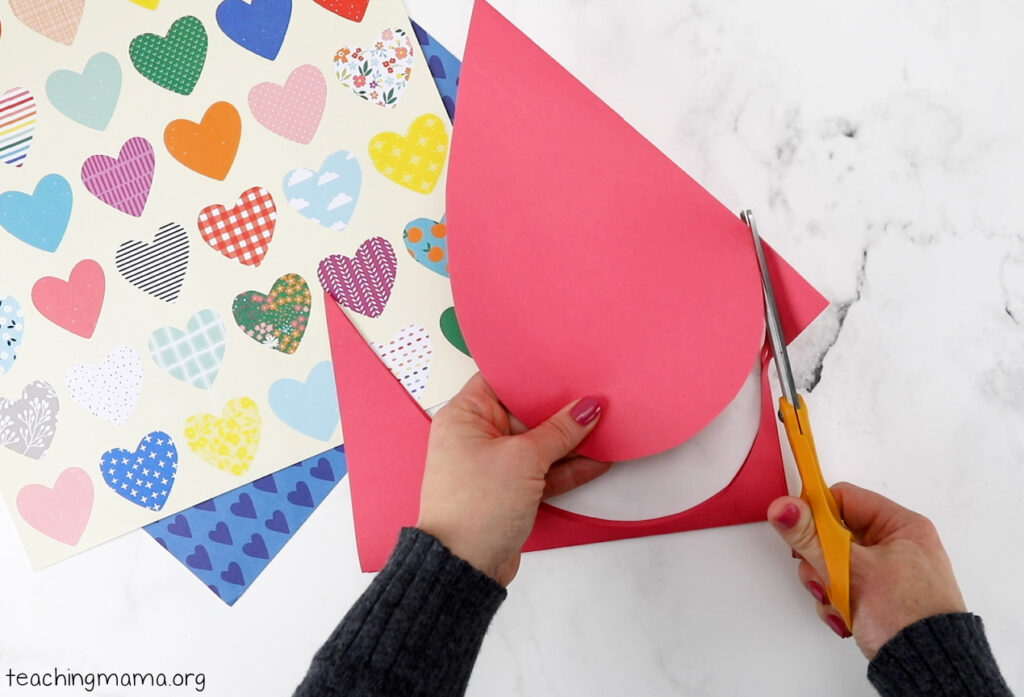 cutting two hearts for handprint project