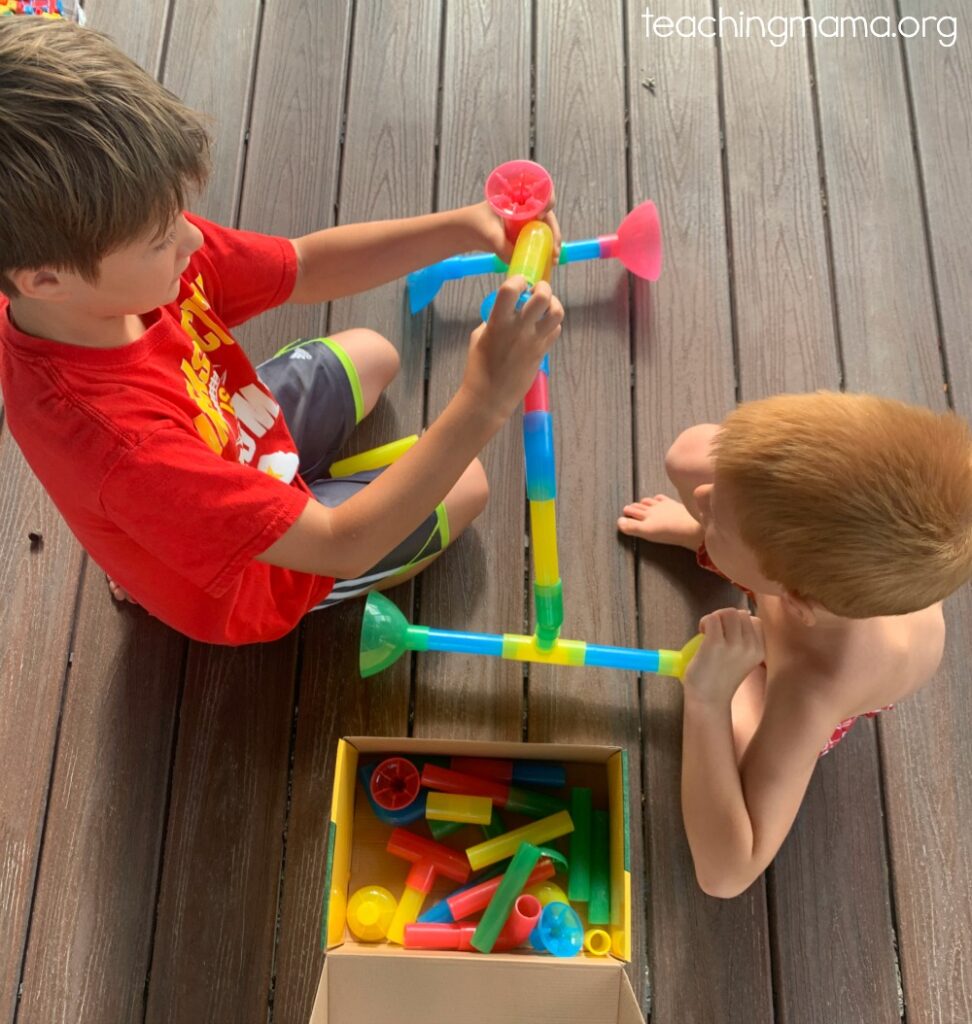 boys playing with waterway pipes