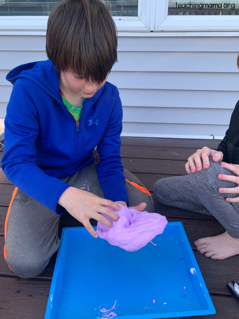 child playing with fluffy slime