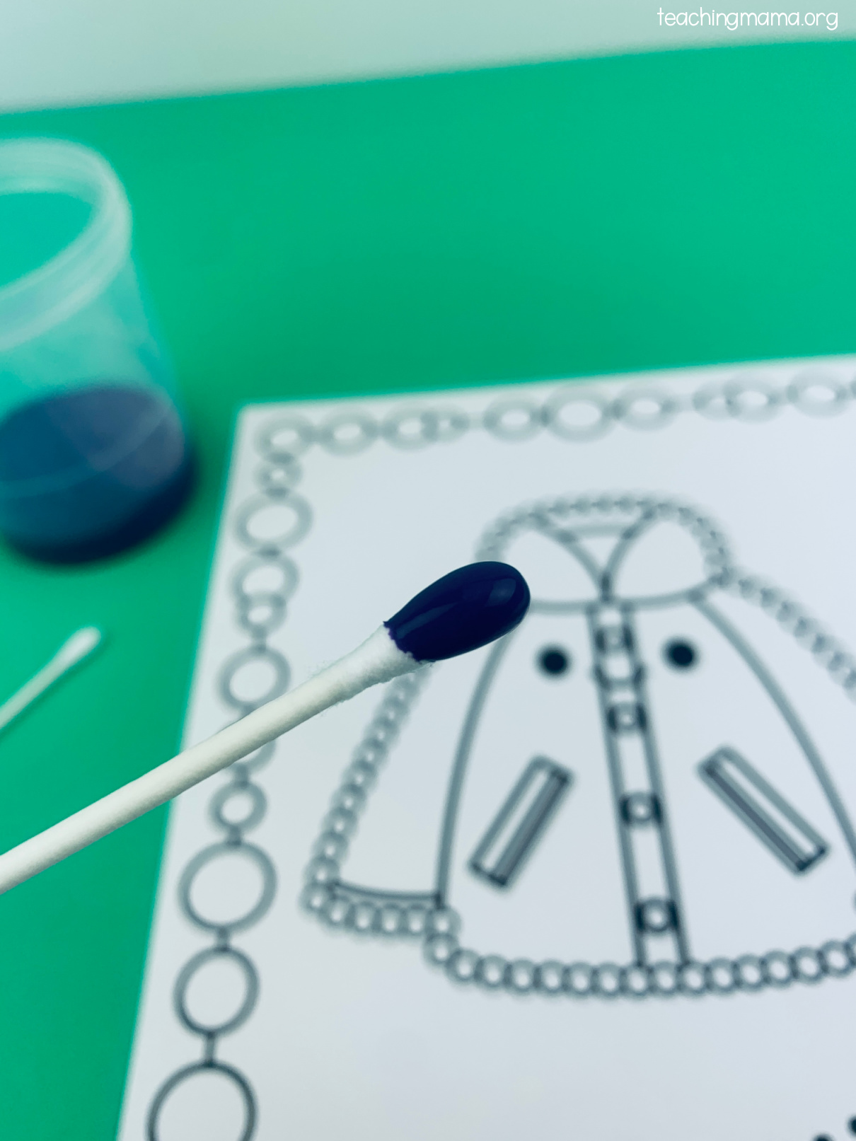 close up of a q-tip dipped in paint