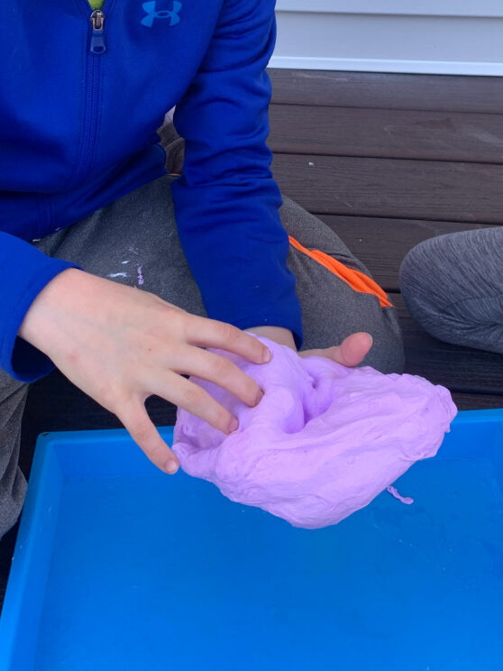 child playing with fluffy slime