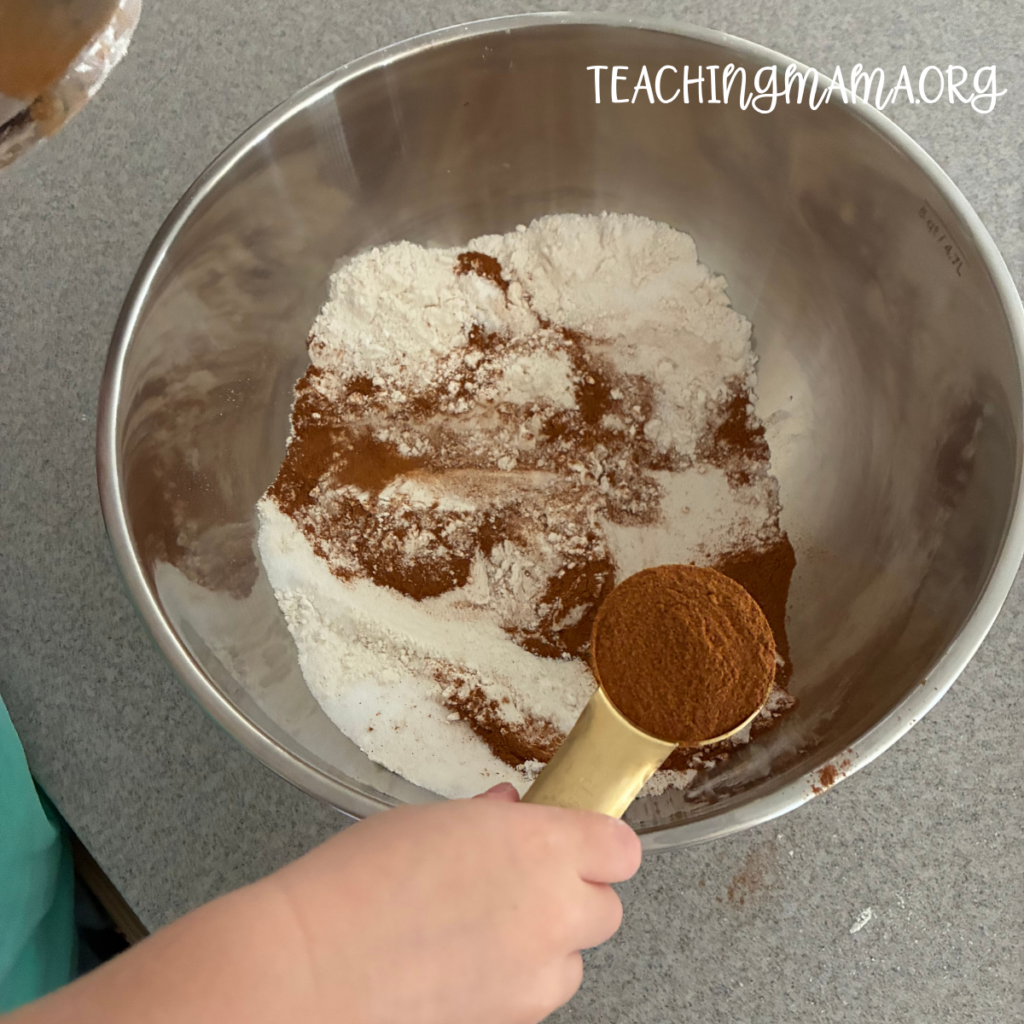 mixing gingerbread playdough ingredients in a bowl