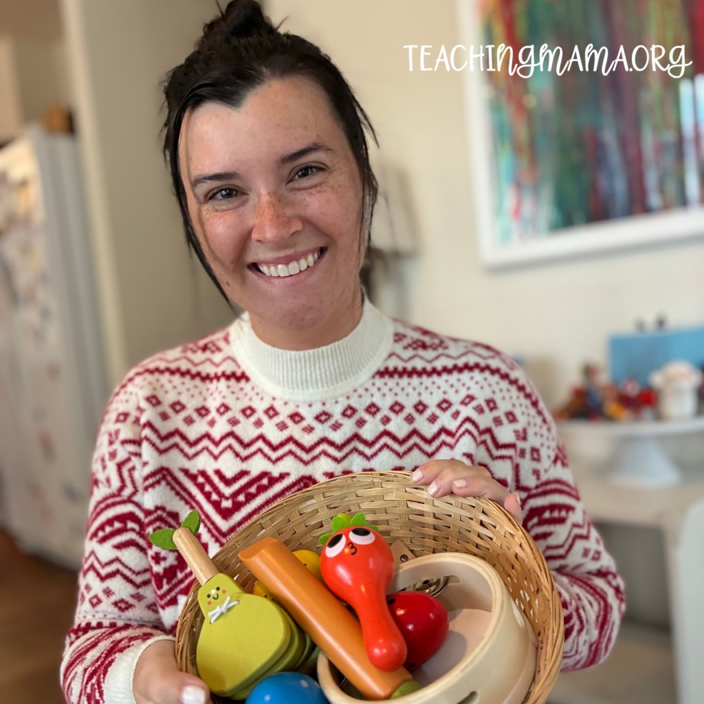 Mom in christmas sweater holding toddler instruments